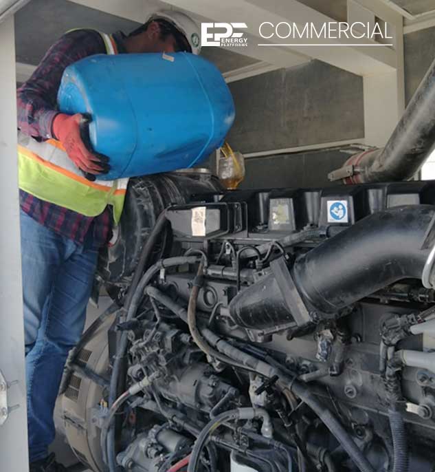 Technician pouring engine oil into generator
